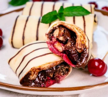 Pancakes with chocolate and cherries